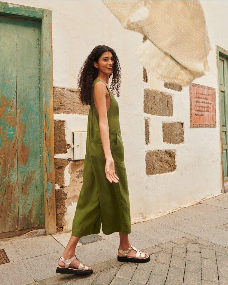 darkhaired woman in khaki linen dungarees